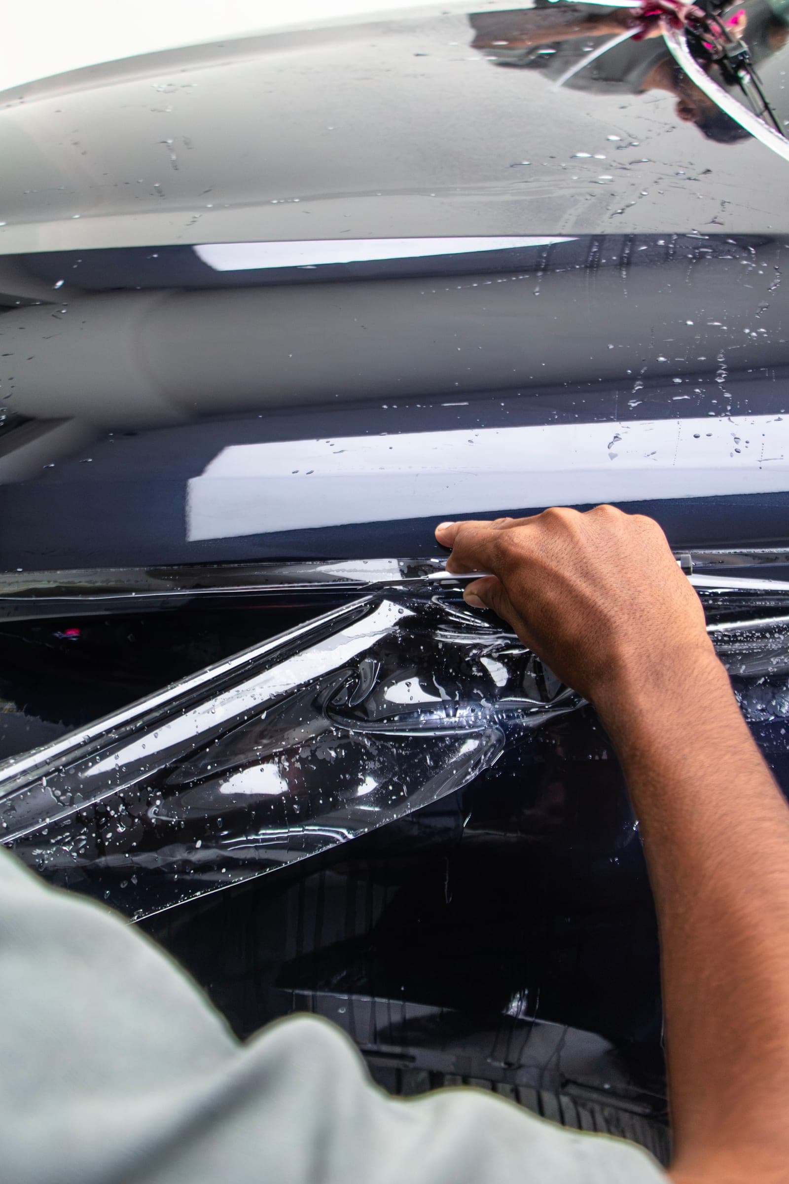 Film being formed over the headlight of a BMW X5