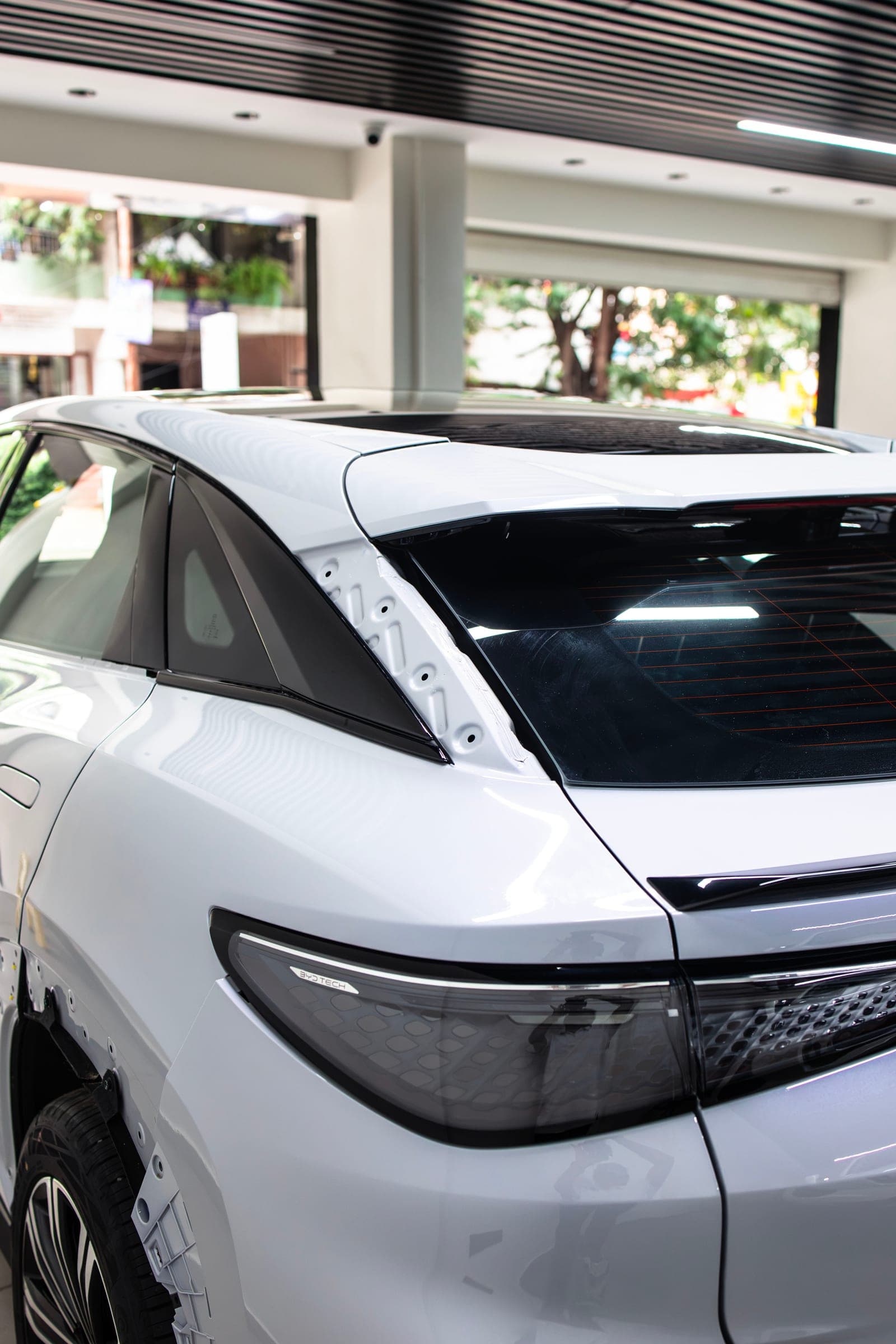 Rear of a white BYD with a black roof in the studio