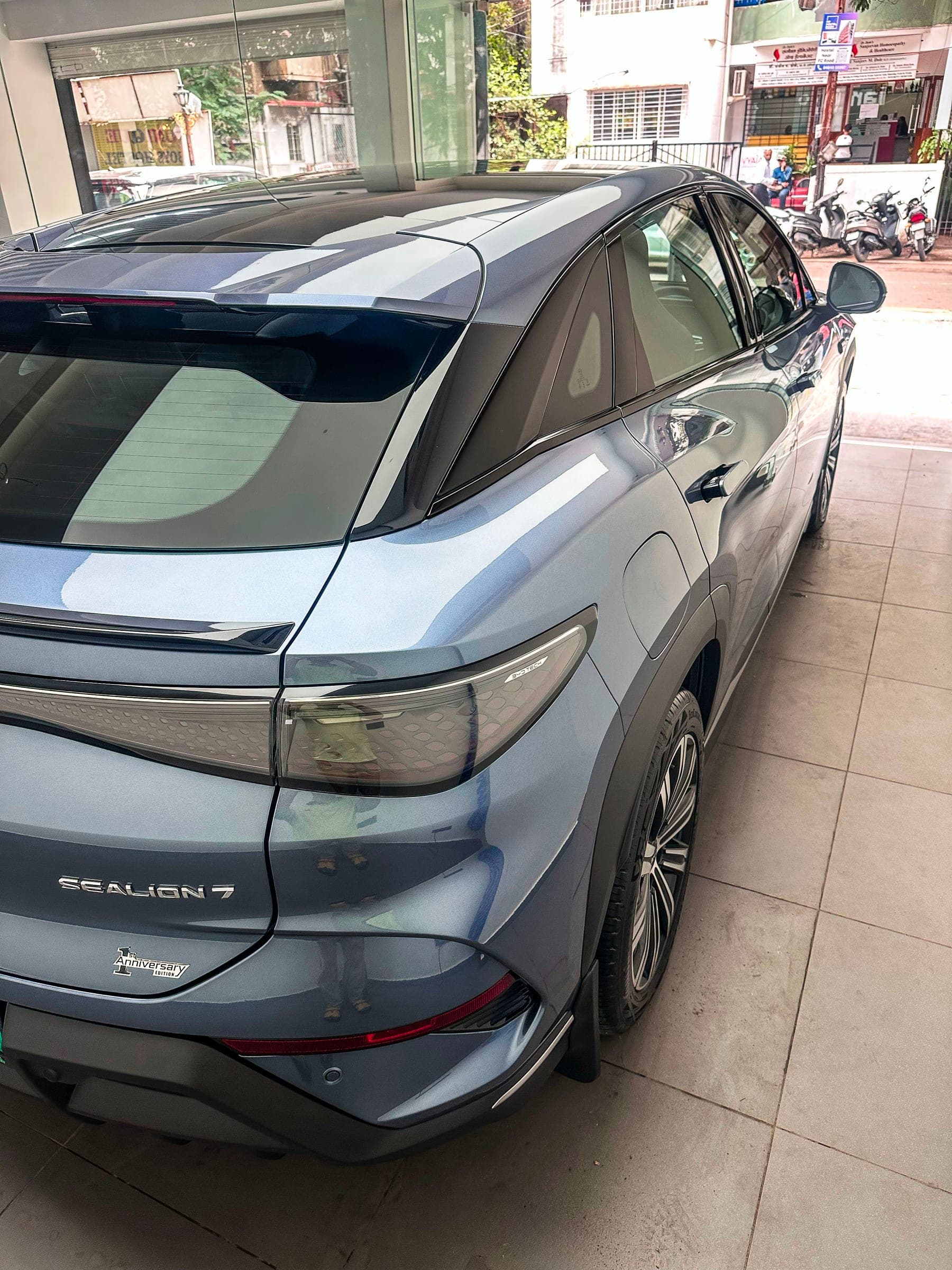 Rear quarter and Sealion 7 badge of a blue-grey BYD