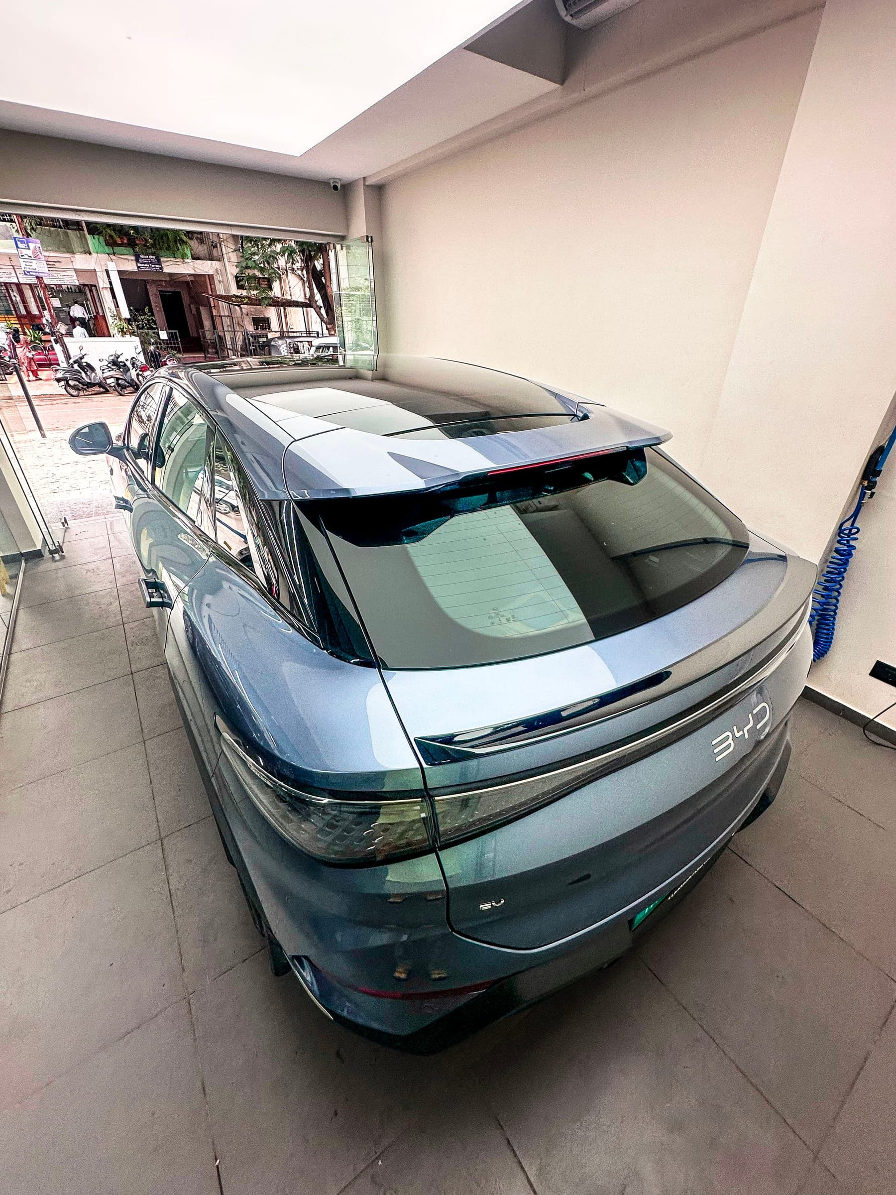 BYD Sealion 7 from the rear three-quarter at the studio entrance