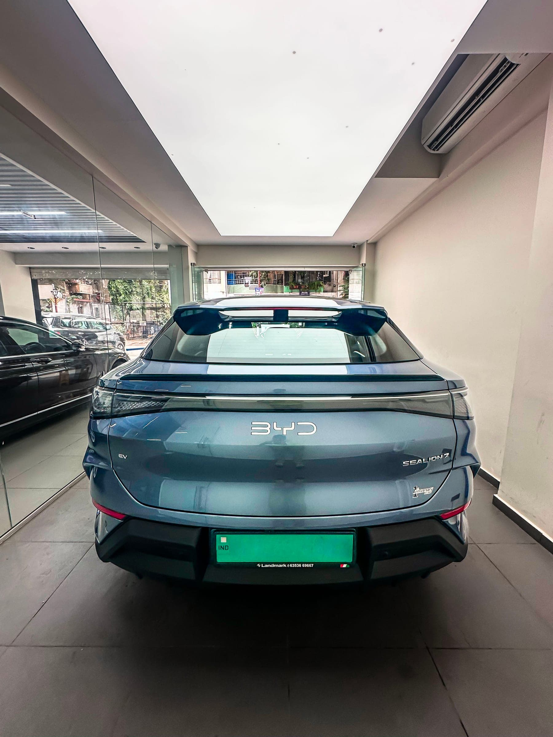 Rear of a blue-grey BYD Sealion 7 in the studio