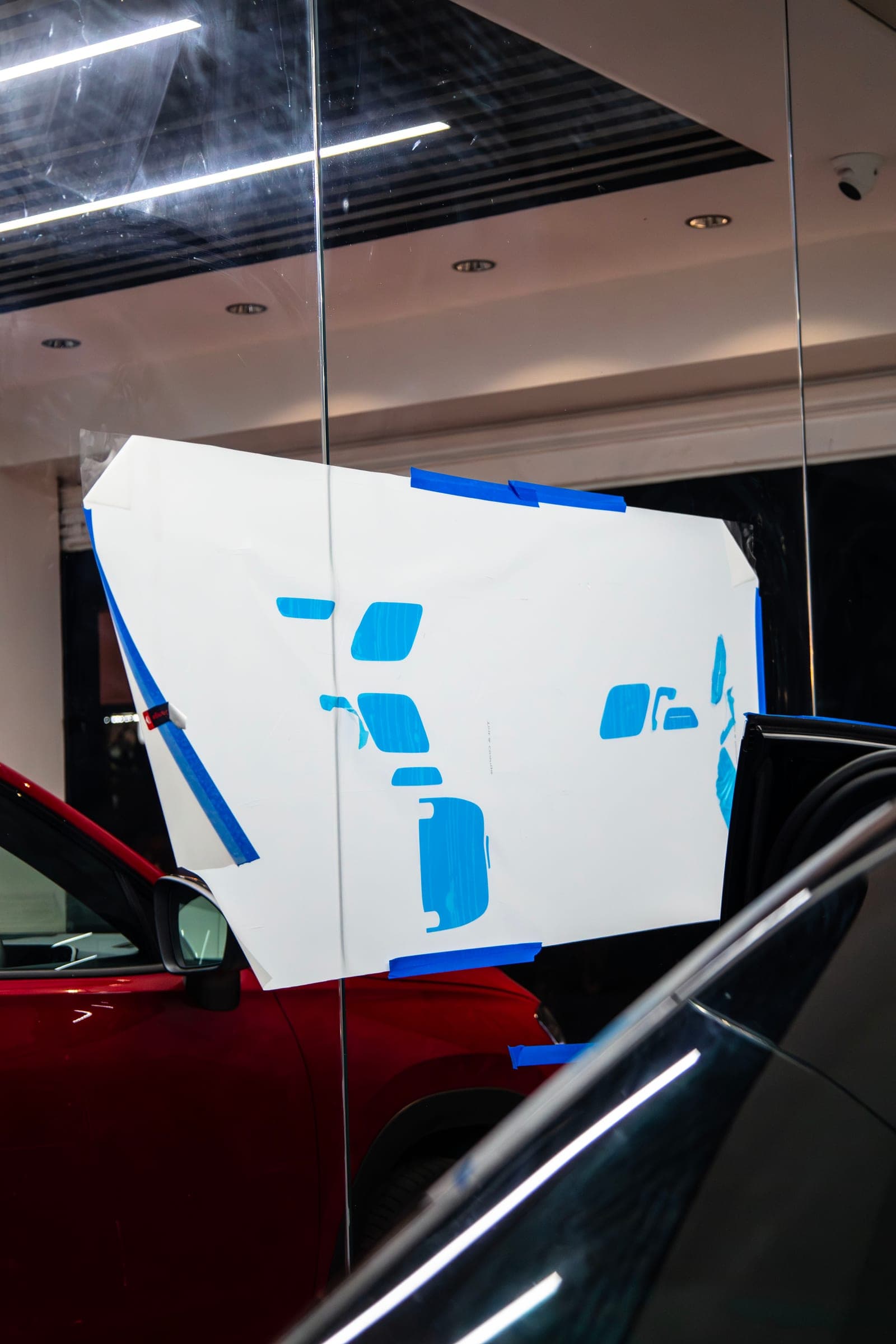 Cut film templates taped to the studio glass beside an E 450