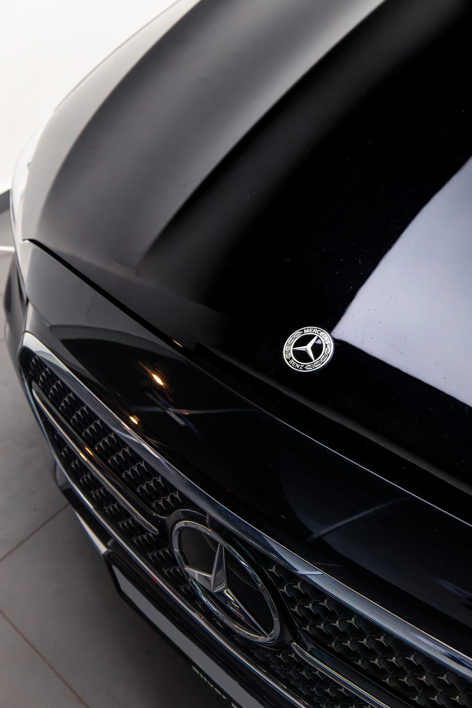 Mercedes star and grille on the gloss black bonnet of an E 450