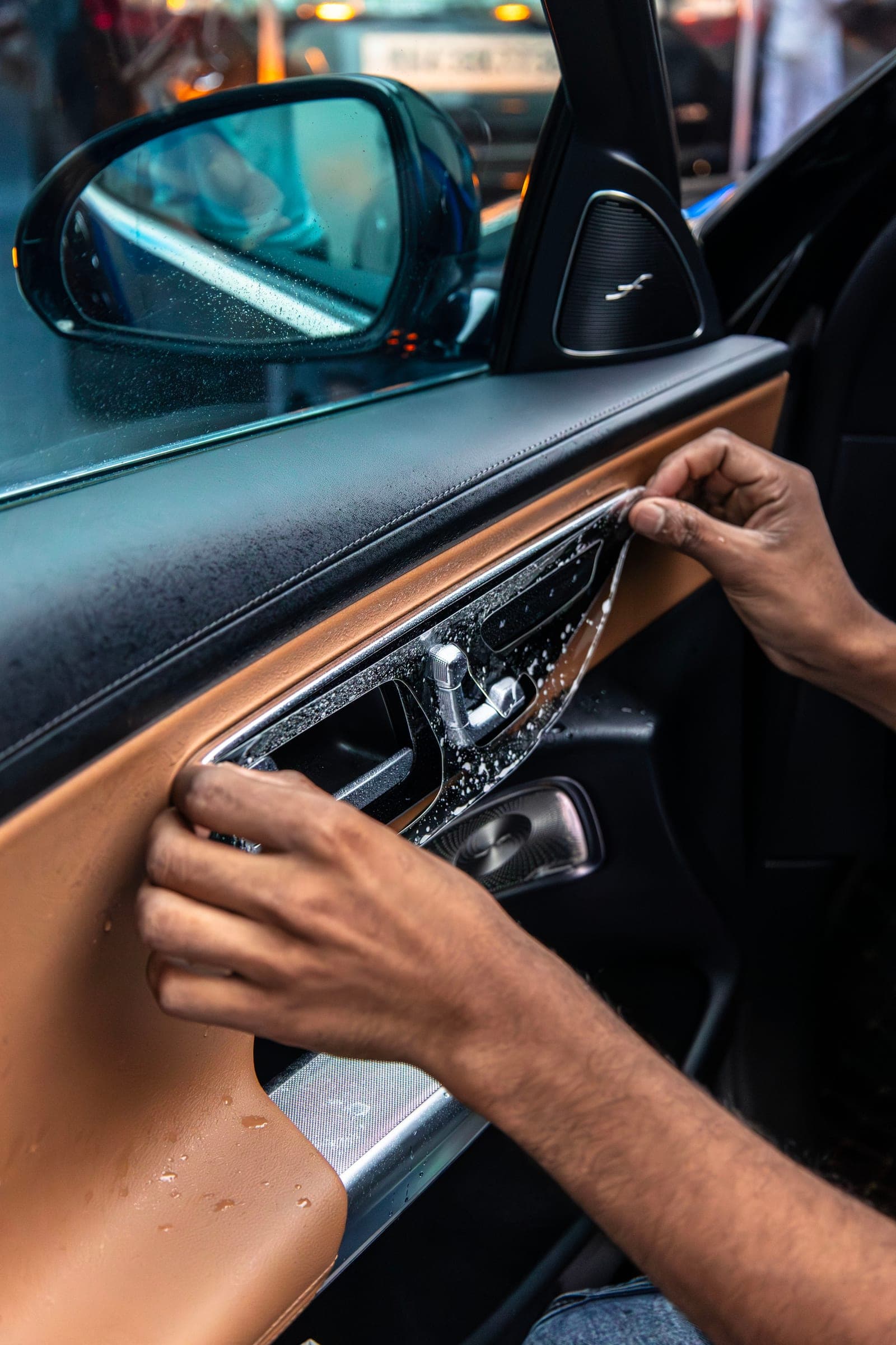 Installer fitting protective film to the door trim of a Mercedes-Benz E-Class