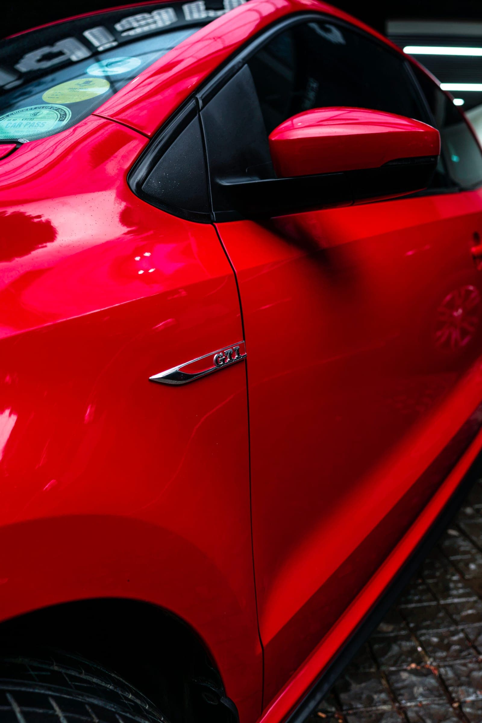 Red wing mirror and door of a Volkswagen Polo GT