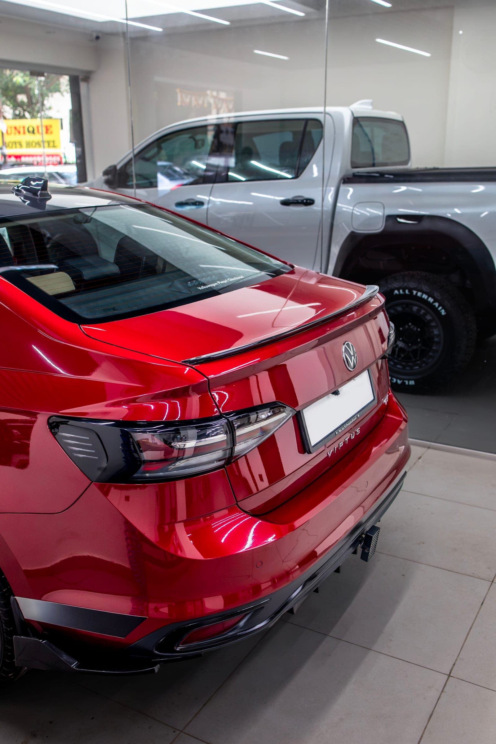 Rear of a red Volkswagen Virtus GT in the studio