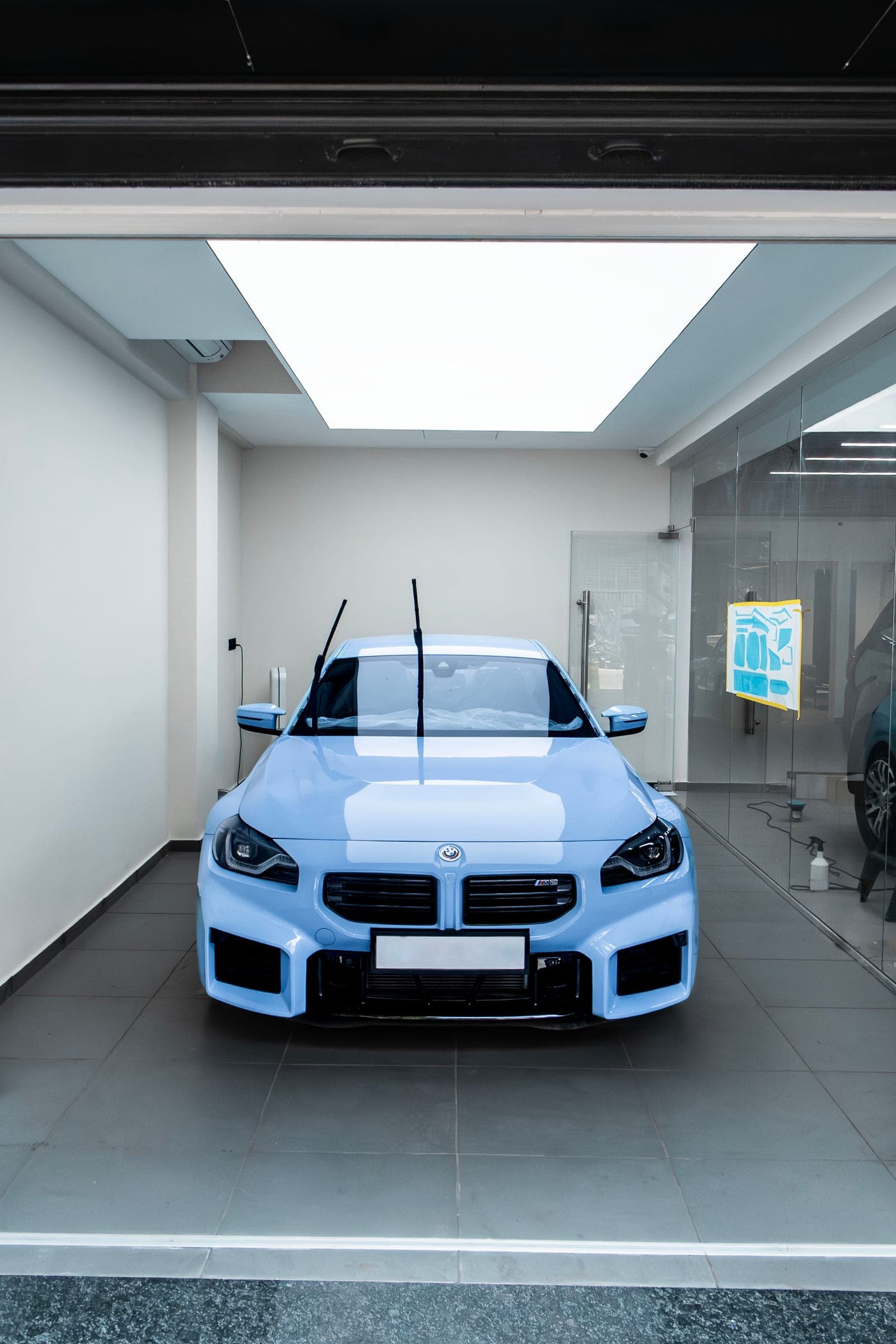 Light blue BMW M2 framed in the studio bay