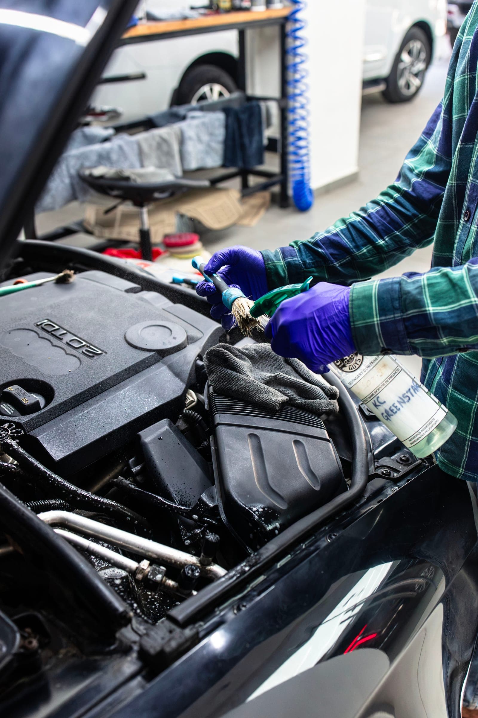 Engine bay of an MG M9 being cleaned and dressed
