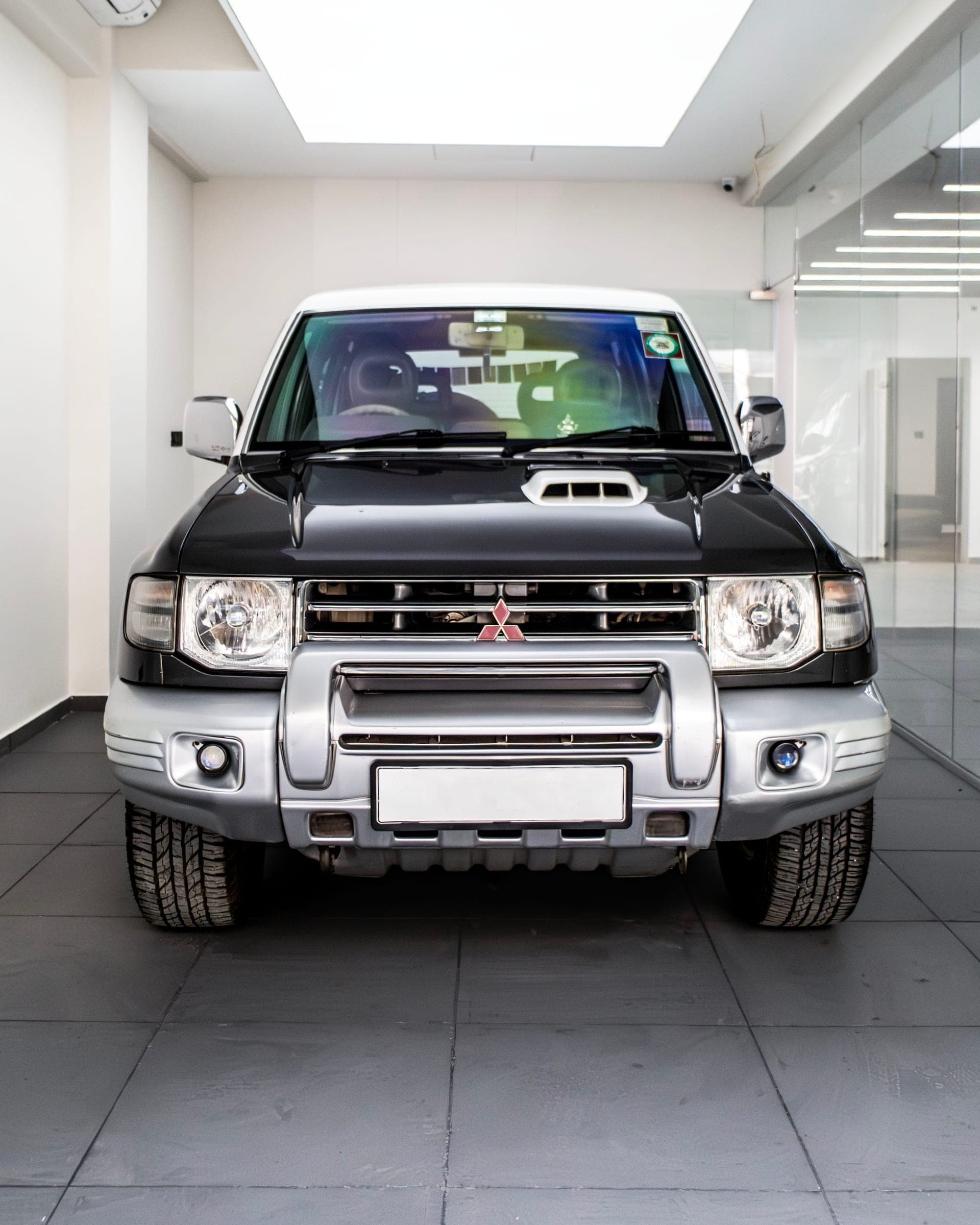 Two-tone Mitsubishi Pajero facing the camera in the studio
