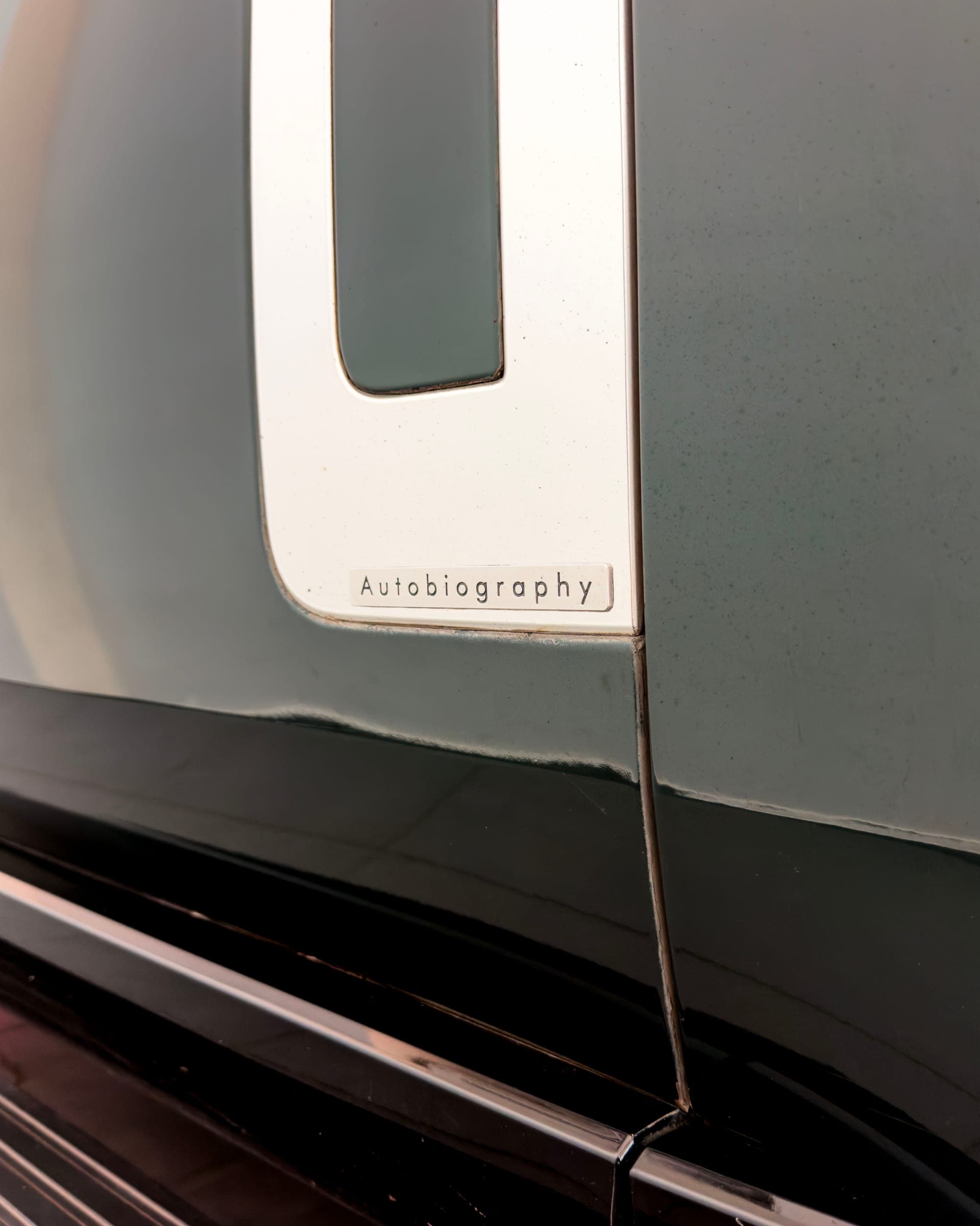 Autobiography script on the lower door of a Range Rover