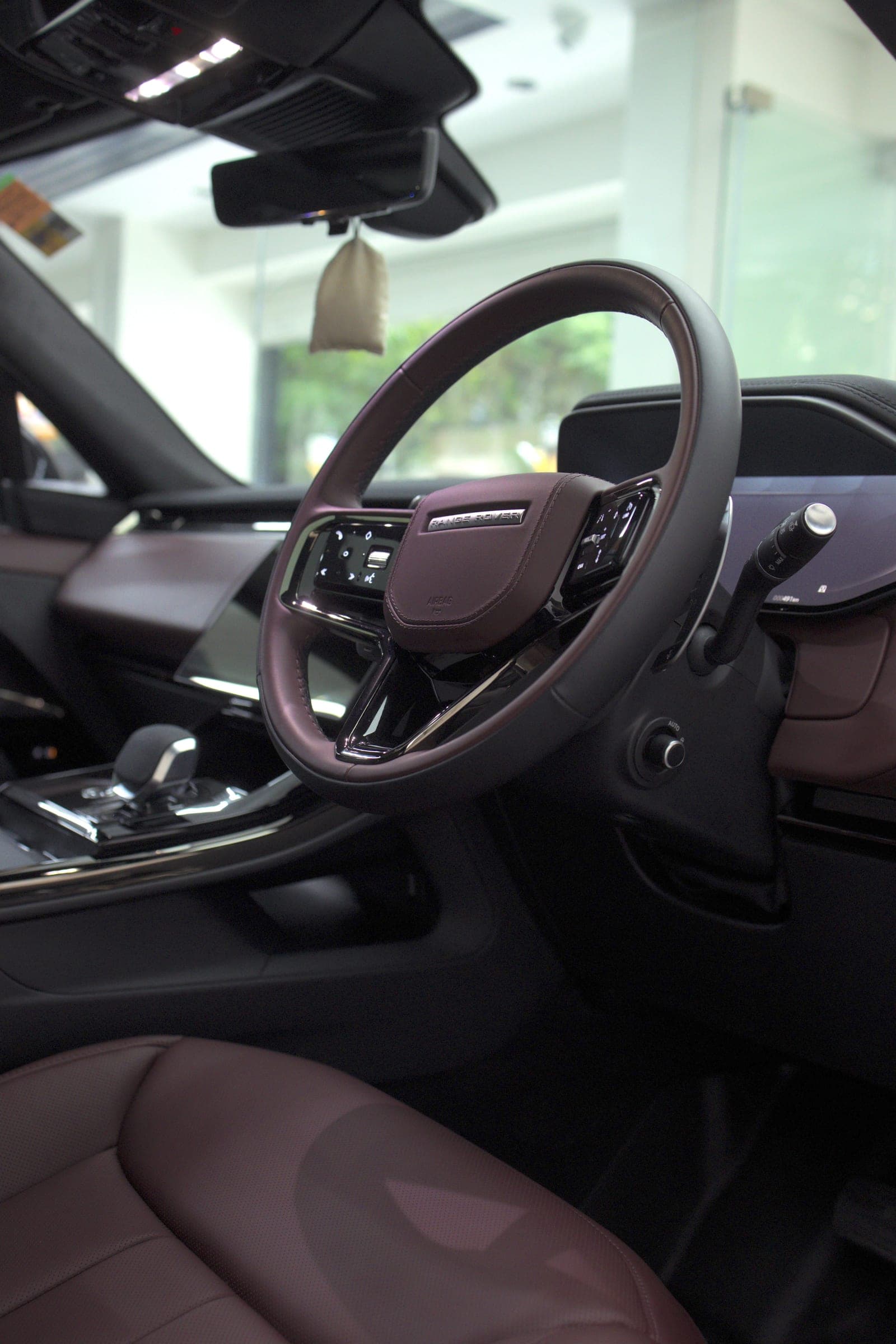Burgundy leather steering wheel and cabin of a Range Rover Sport