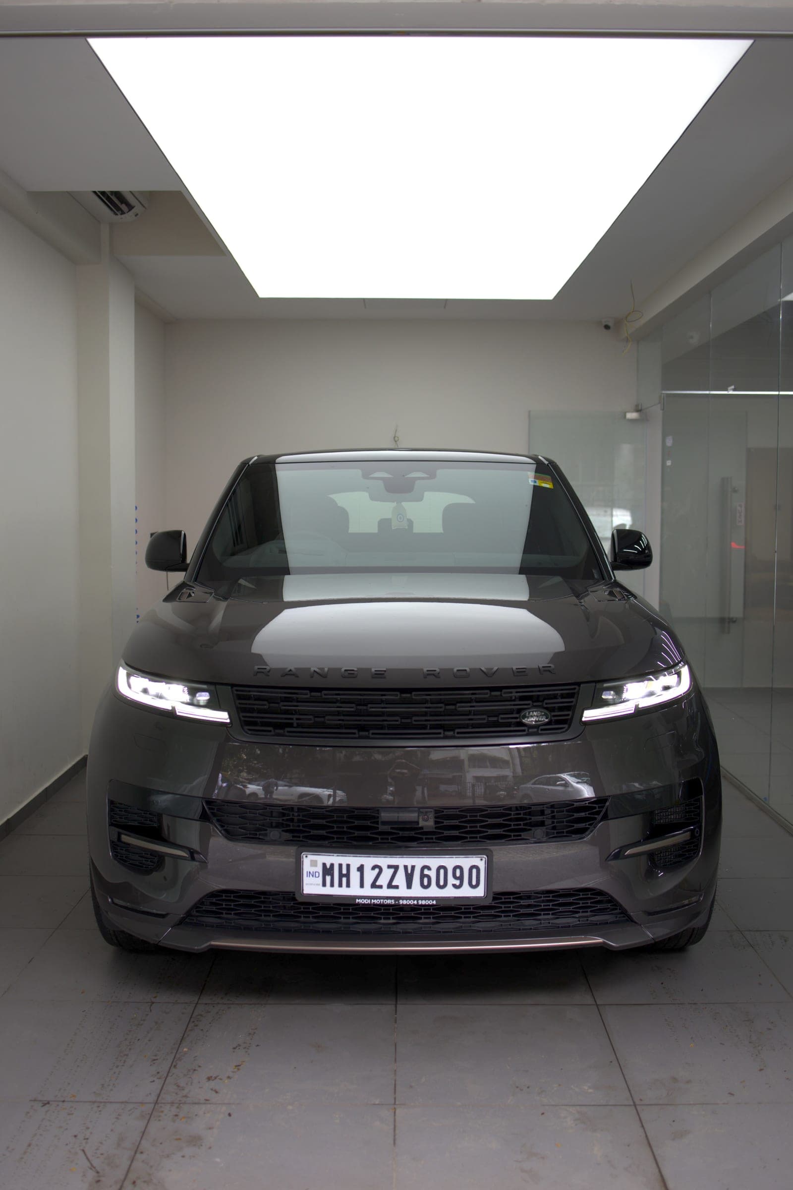 Grey Range Rover Sport facing the camera under the studio light box