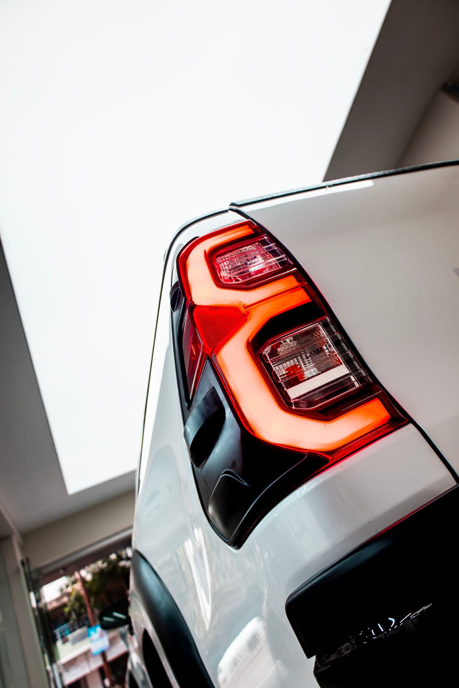 LED tail-light on the rear corner of a white Toyota Hilux