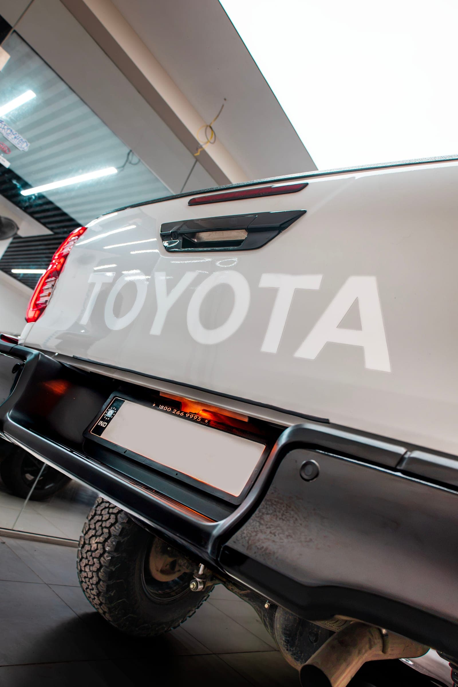 TOYOTA lettering across the tailgate of a white Hilux